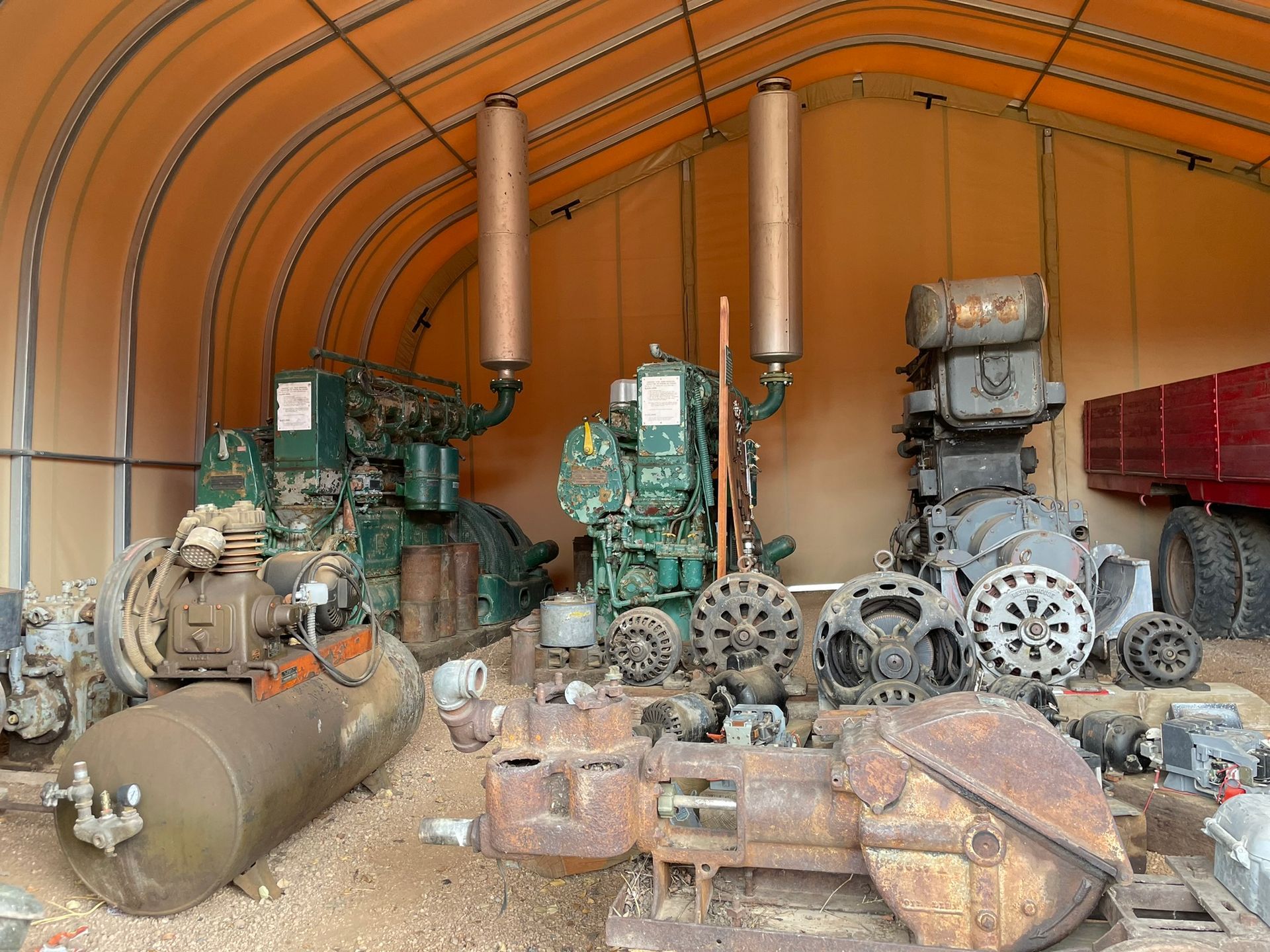 A warehouse filled with lots of machinery and a red truck