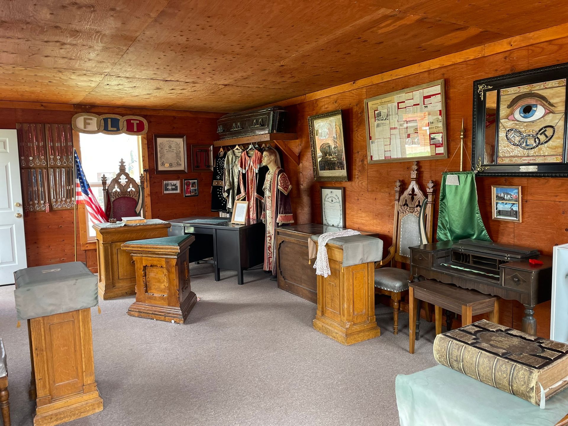 A room with a lot of furniture and pictures on the wall.