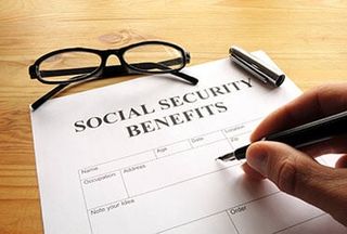 Hand filling out paperwork — Social security attorney in Portland, ME