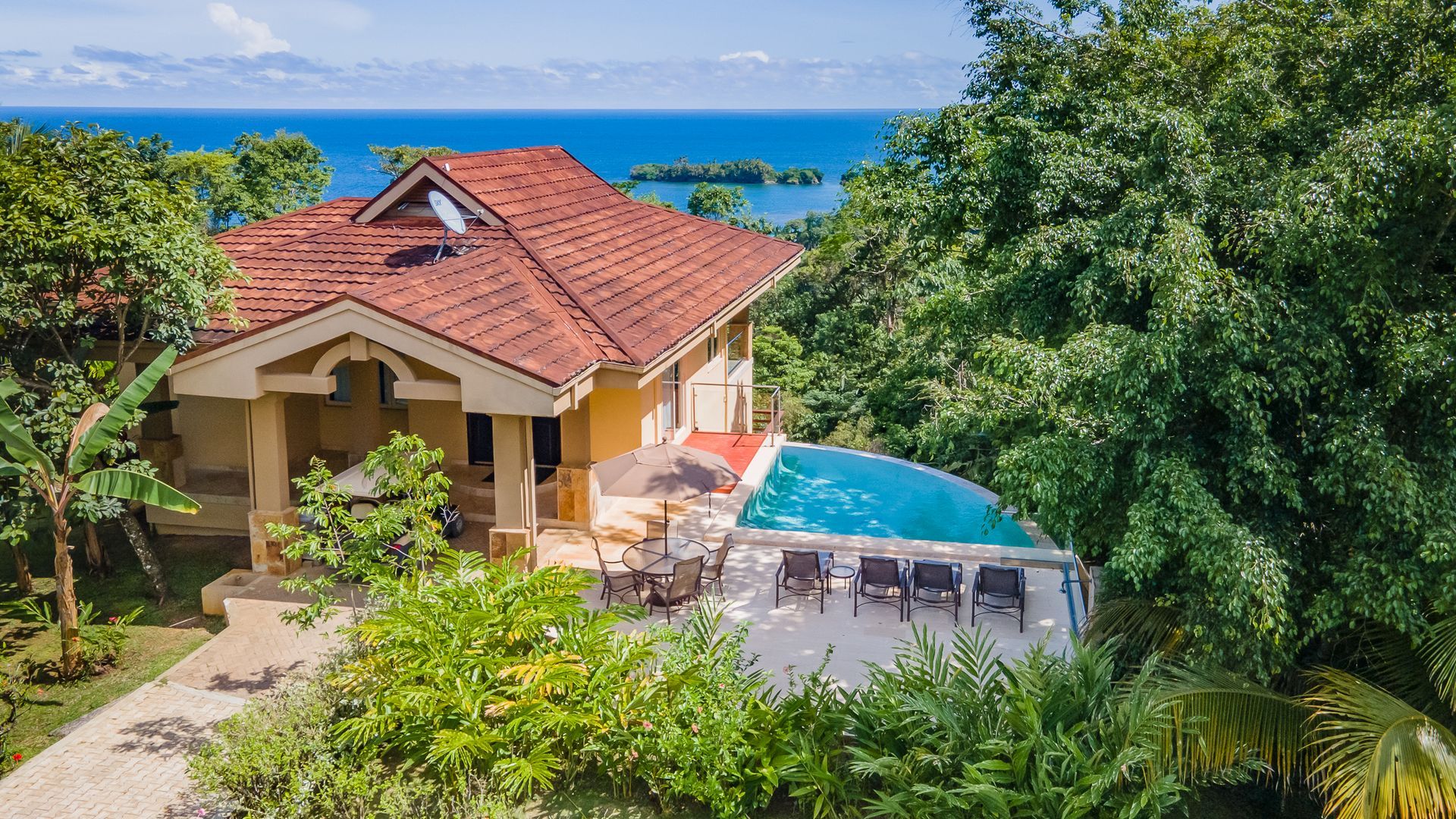 A large swimming pool with a view of the ocean