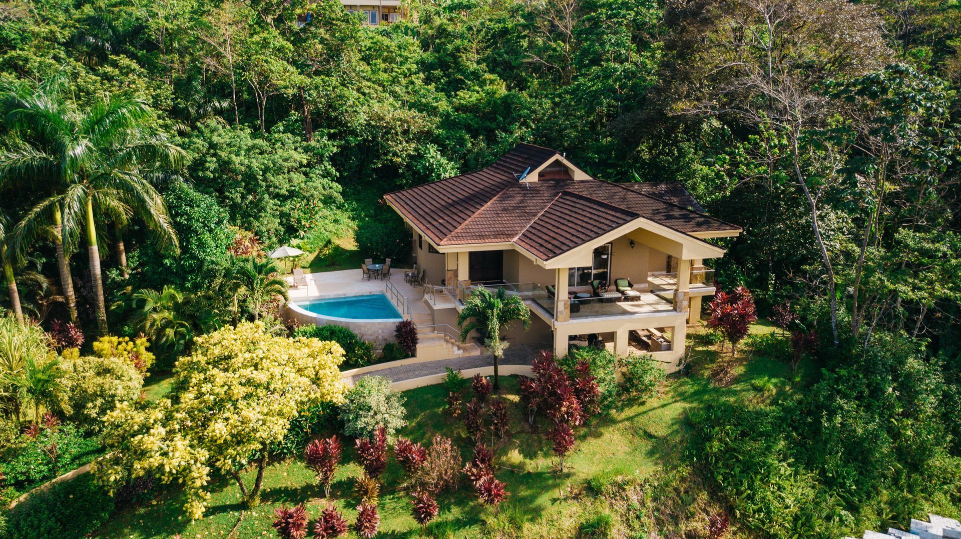 A large house with a swimming pool in front of it