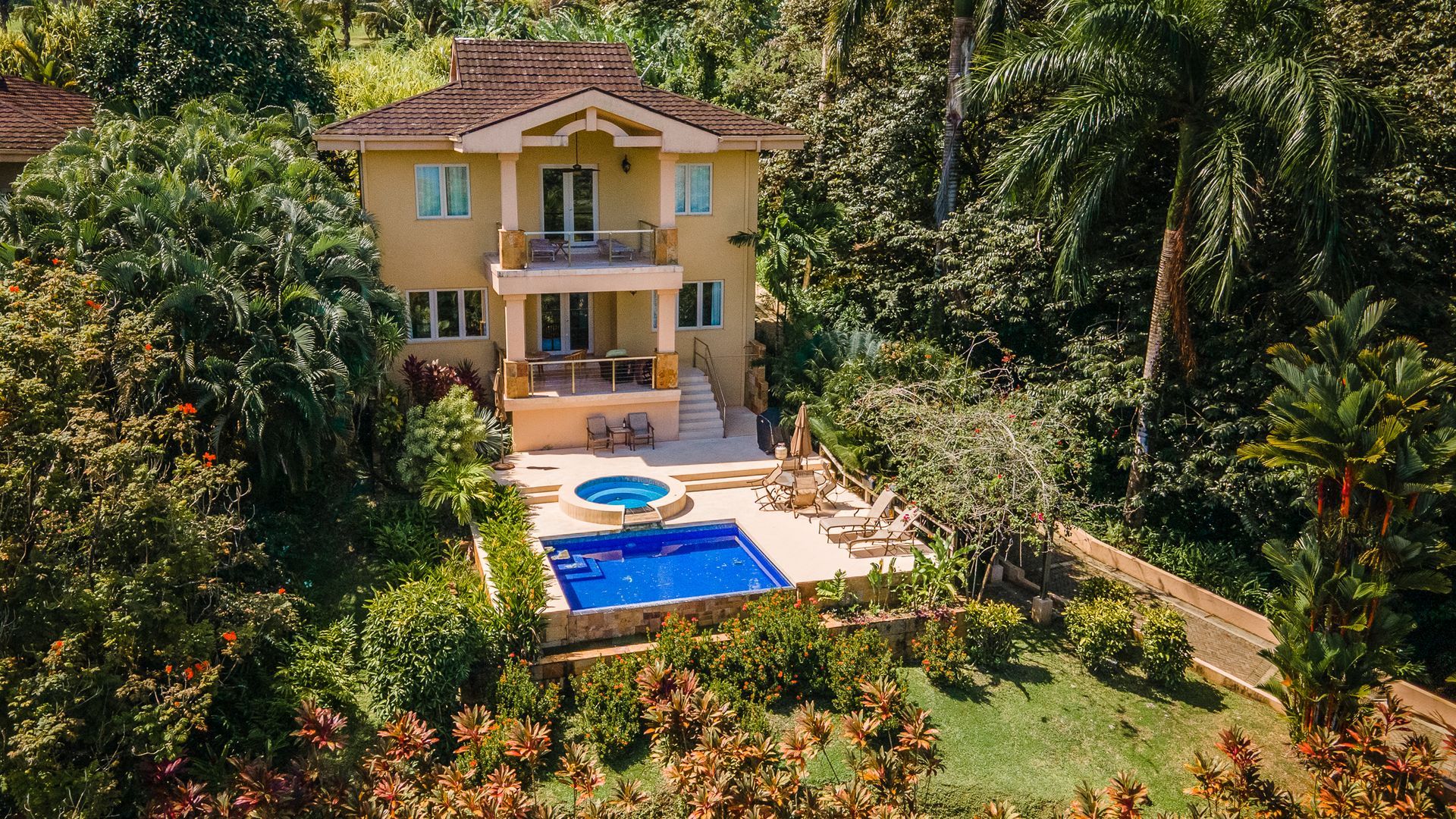 A large house with a swimming pool in front of it