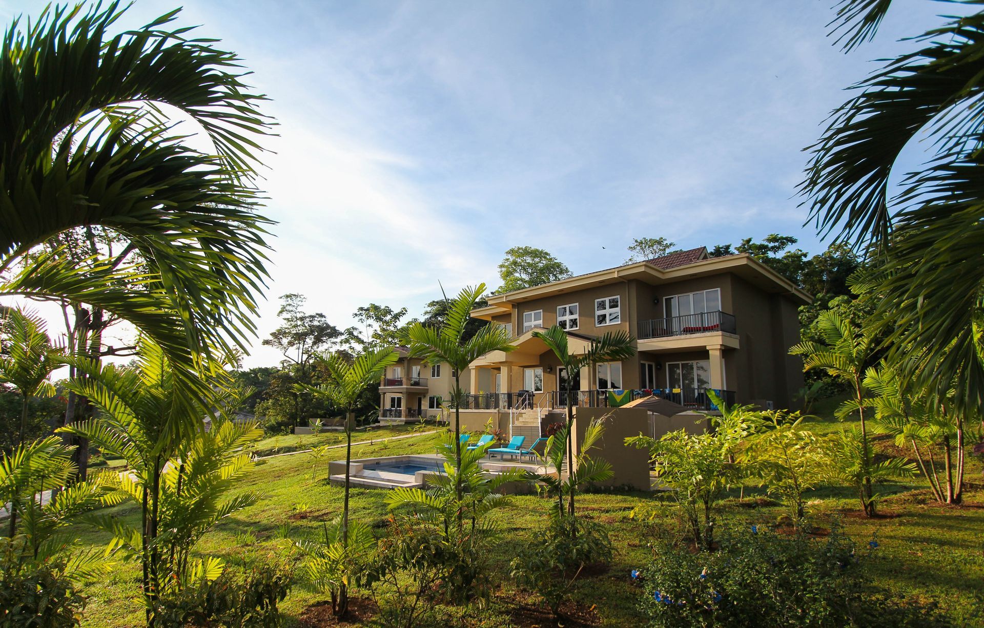 A large house in the middle of a lush green field