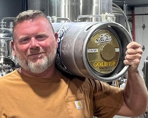 Brad Schweitzer Holding Keg of Gold Top Lager
