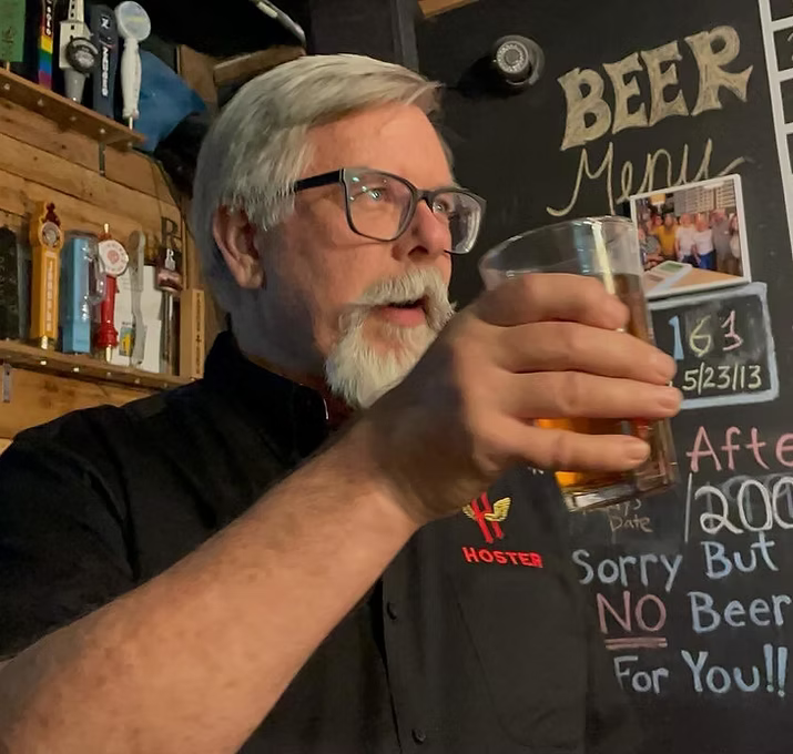 Victor Aume, Brewer Emeritus, holding a pint of beer