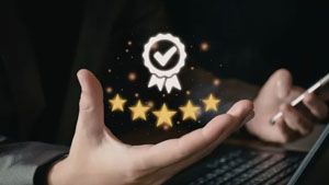 A person holds a digital icon of a star-rated badge with a checkmark, symbolizing high quality or customer satisfaction.