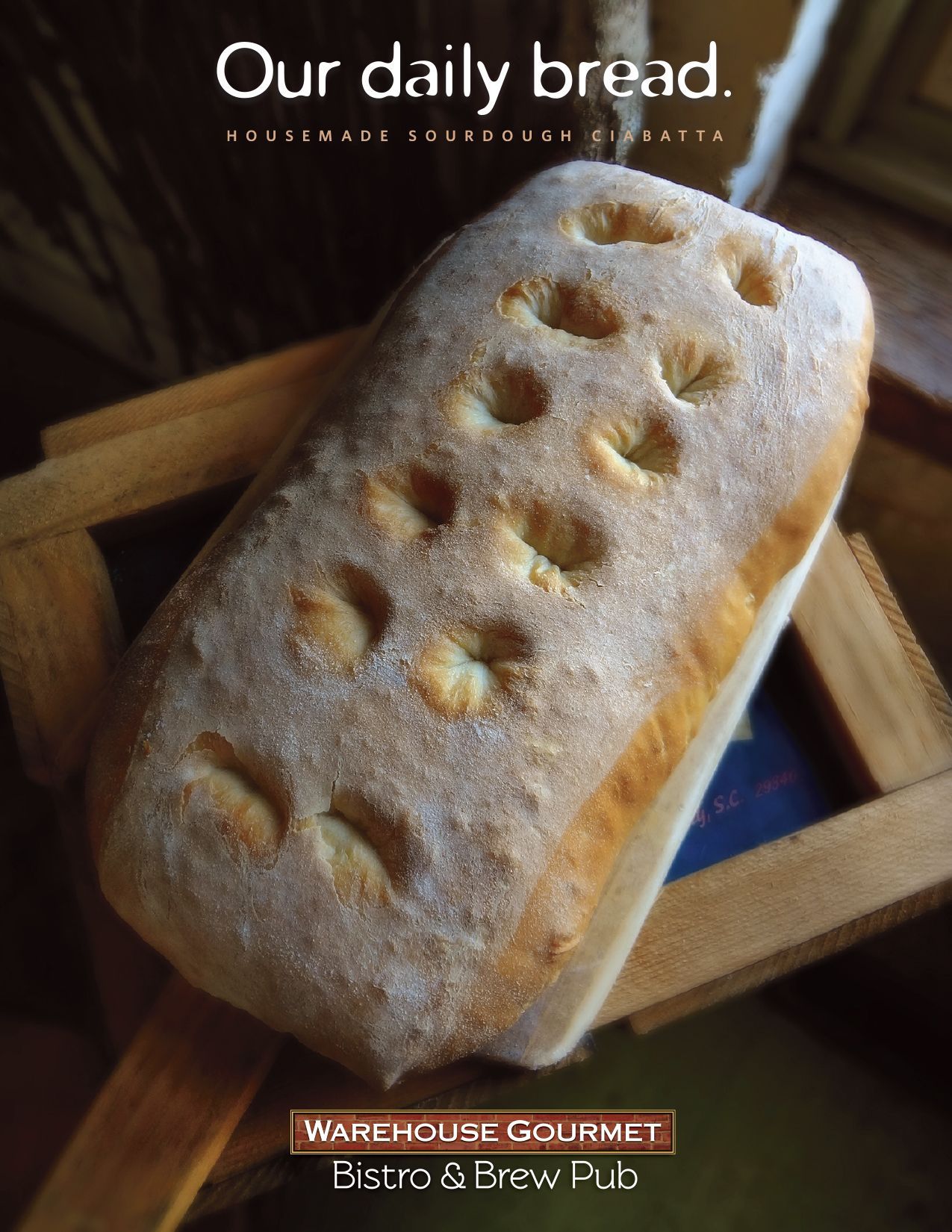 A loaf of dimpled bread sits on a wooden board above the text 