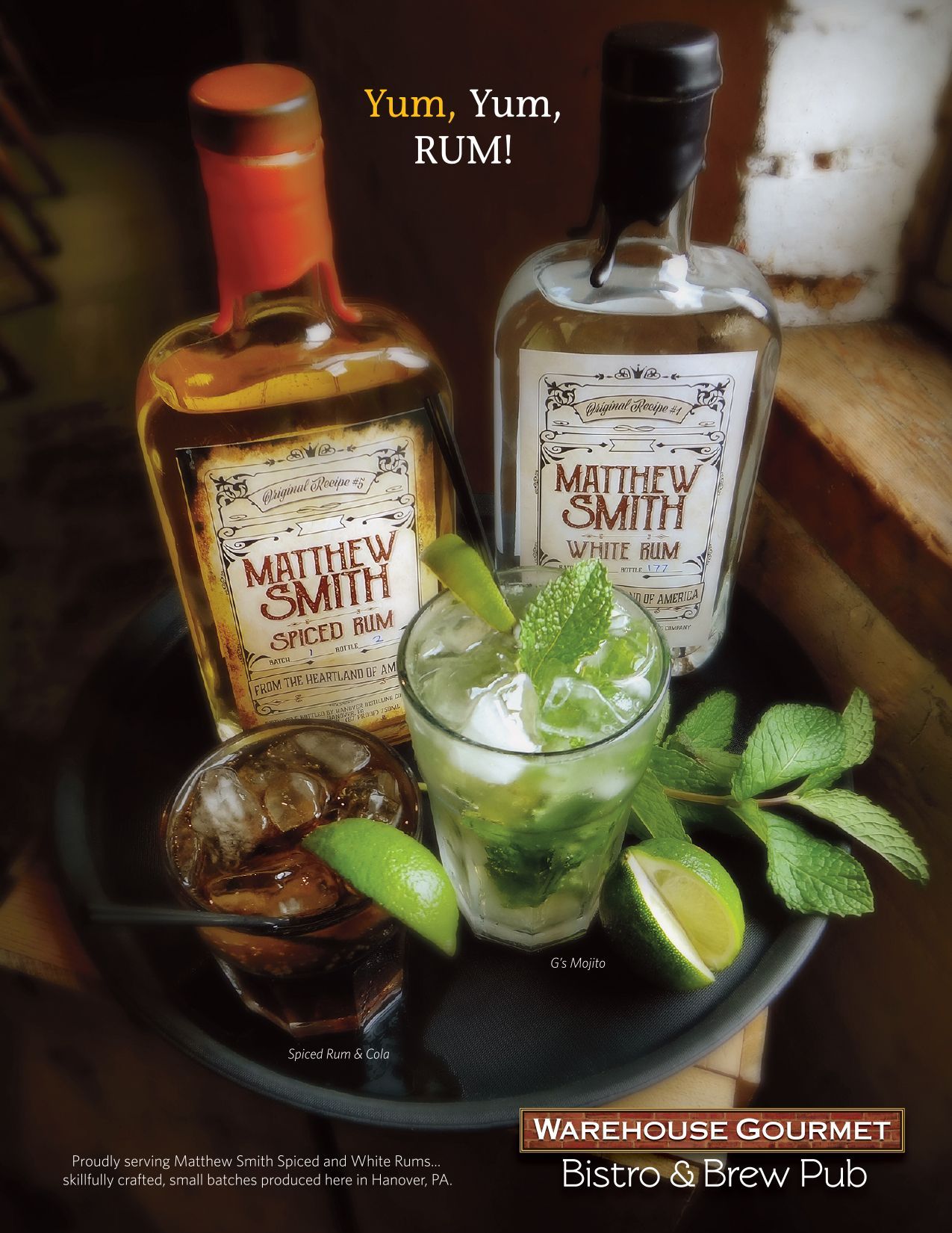 Two bottles of Matthew Smith rum and two garnished cocktails on a tray at Warehouse Gourmet Bistro & Brew Pub.