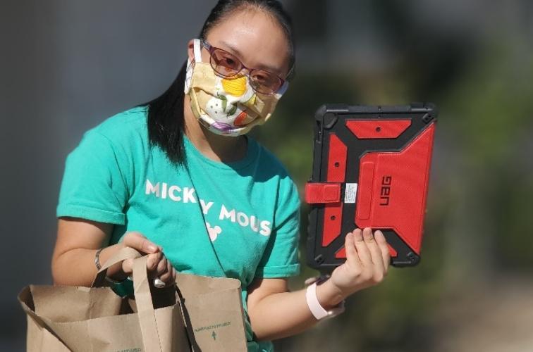 CAA student showing her new iPad loaner