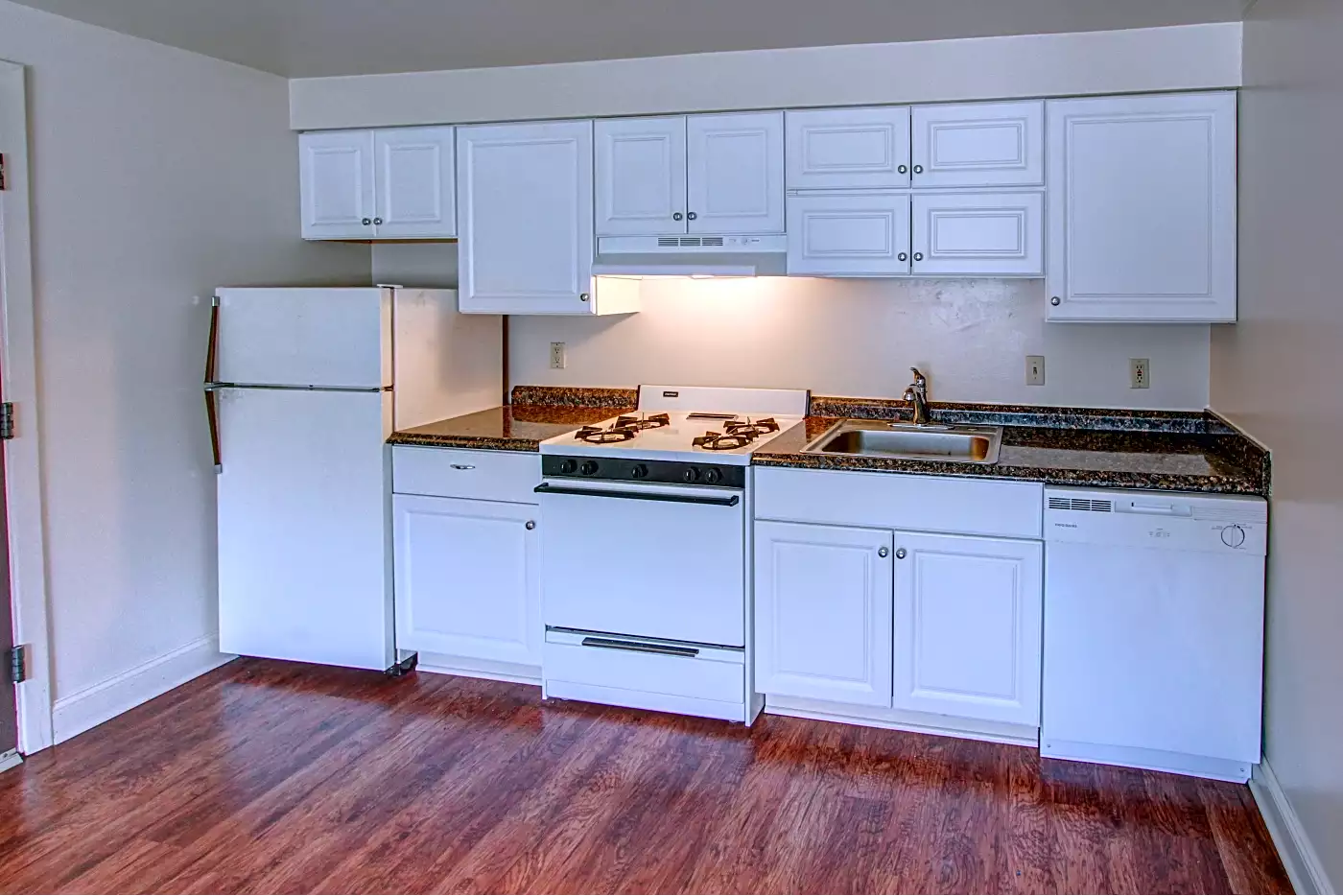 Kitchen with white cabinets and appliances