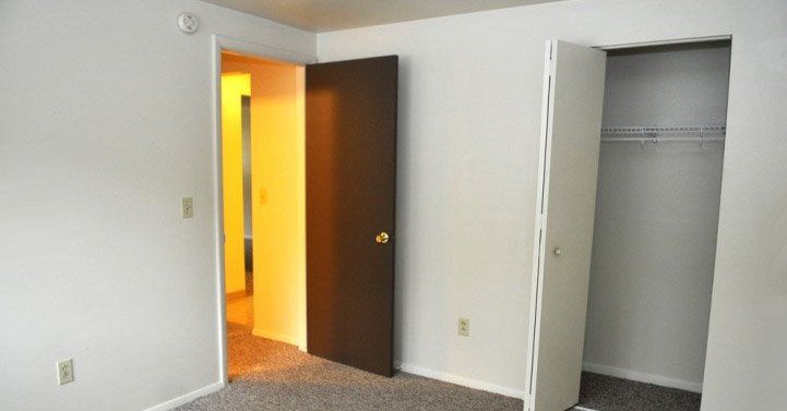 Bedroom with closet and doors open