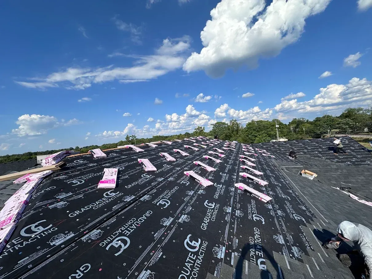 A large roof with a blue sky and clouds in the background
