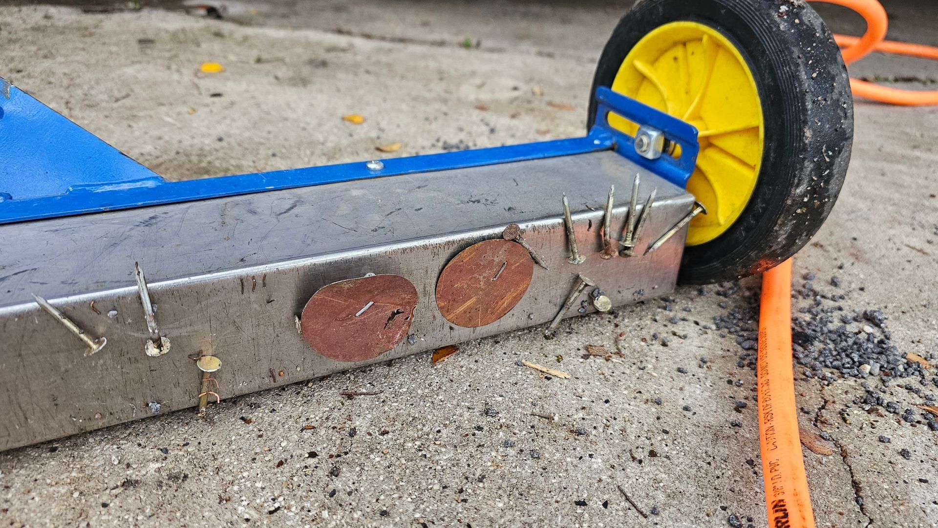 magnet sweeper cleaning up nails and metal