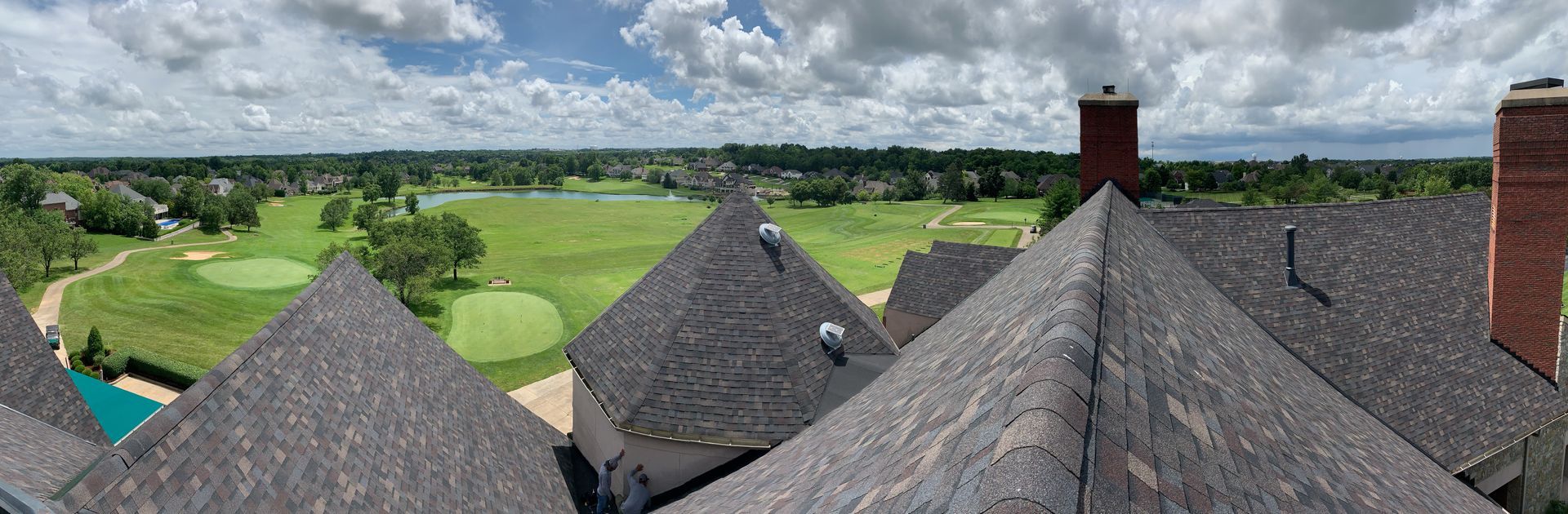 A view of a golf course from the roof of a house