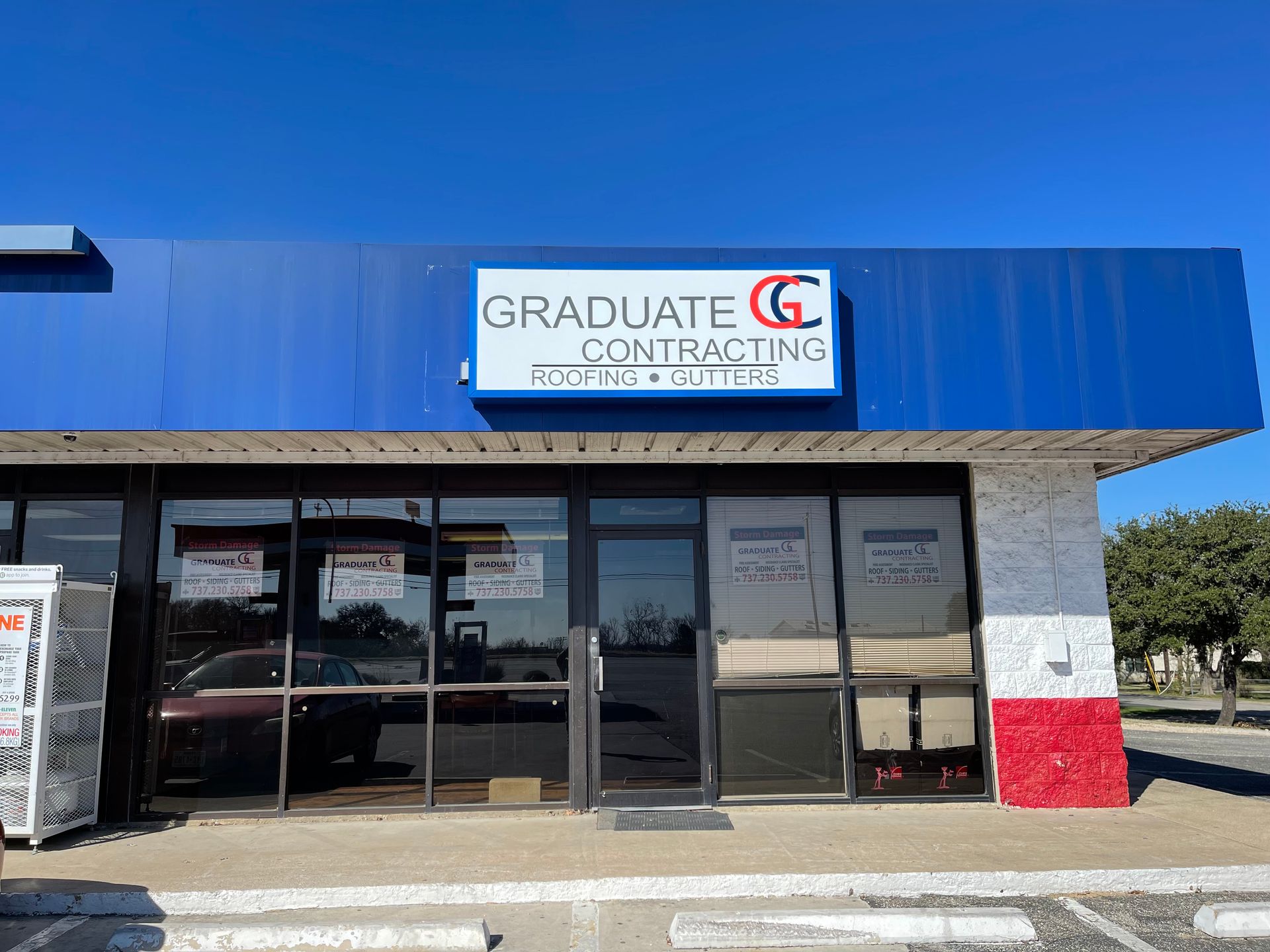 The front of a building with a sign that says `` graduate contracting ''.