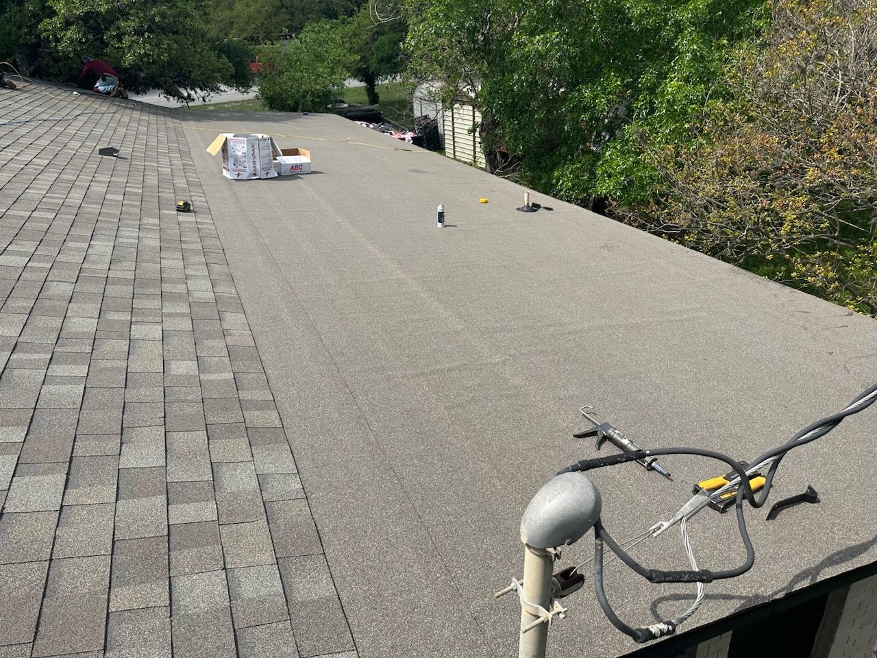 A roof with a lot of wires hanging off of it