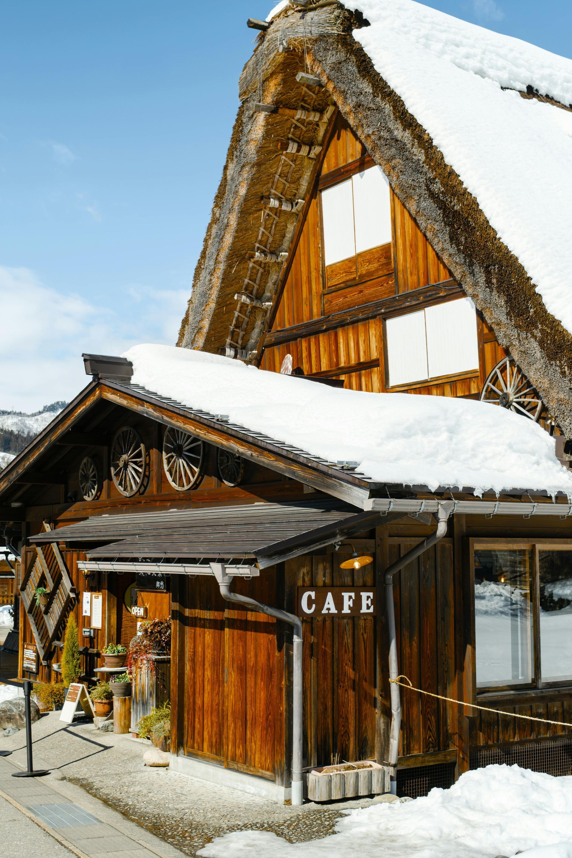 Thatched roof, covered in snow. Wooden exterior