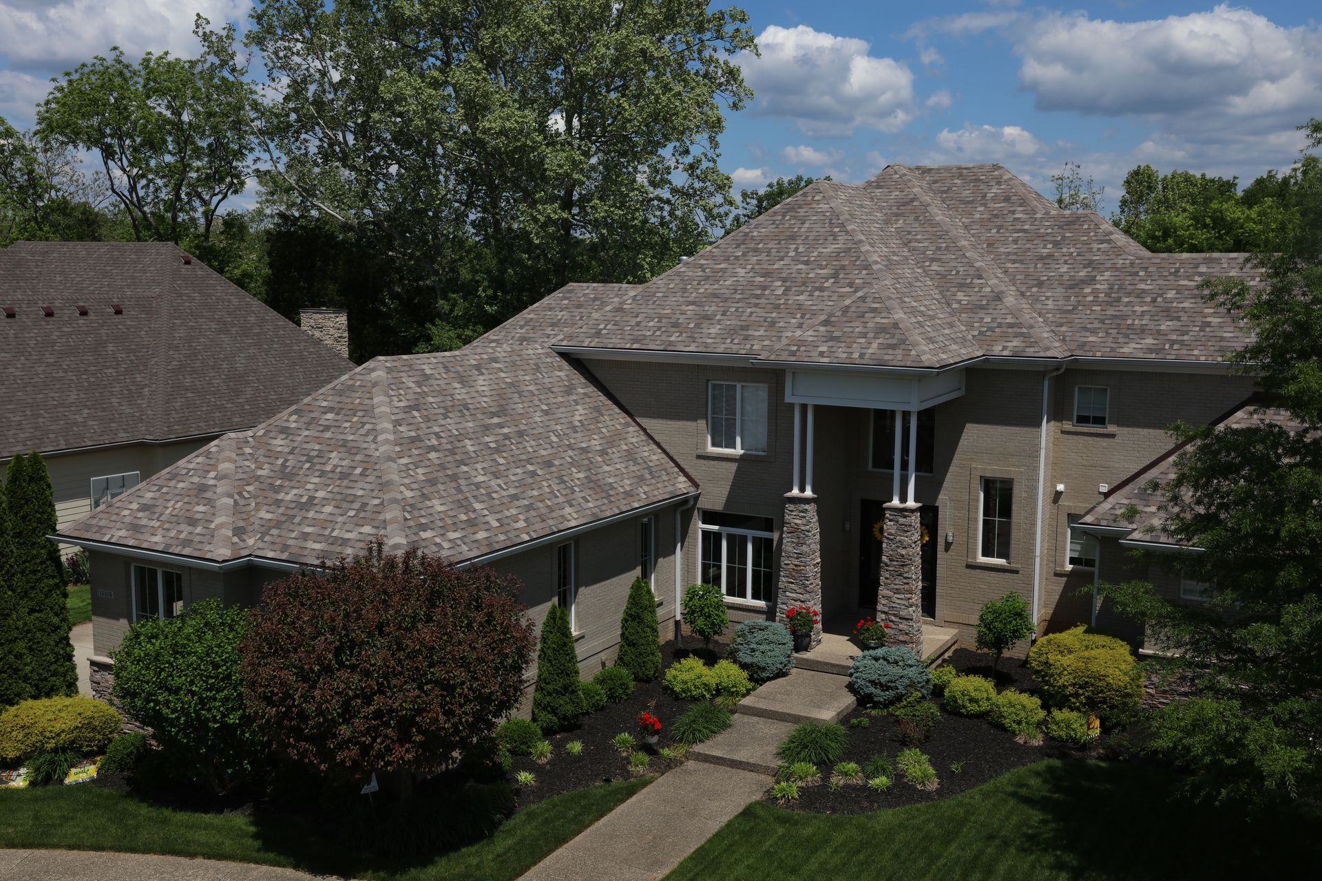 An aerial view of a house with a gray roof