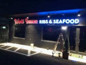 Restaurant exterior with lit sign, 