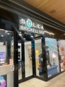 Solea Brickell Spa storefront with glass doors, illuminated sign.