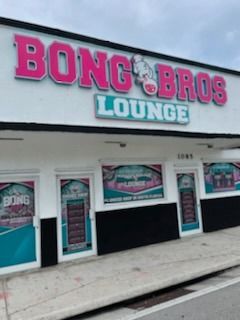 Bong Bros Lounge storefront with pink and teal sign; shop exterior.