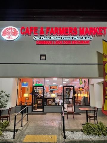 Cafe & Farmers Market storefront with red sign, Caribbean & Soul Food restaurant.