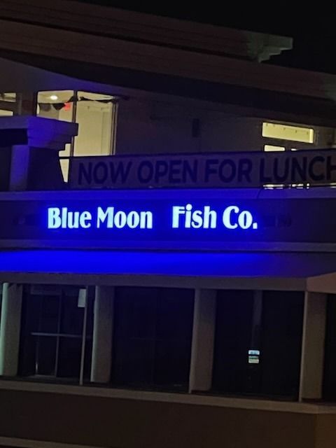 Blue Moon Fish Co. restaurant at night, neon sign 
