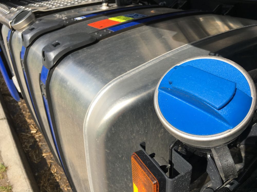 Close-up Of A Blue Diesel Exhaust Fluid Tank Cap On A Truck — Britek Automotive in Bentley Park, QLD