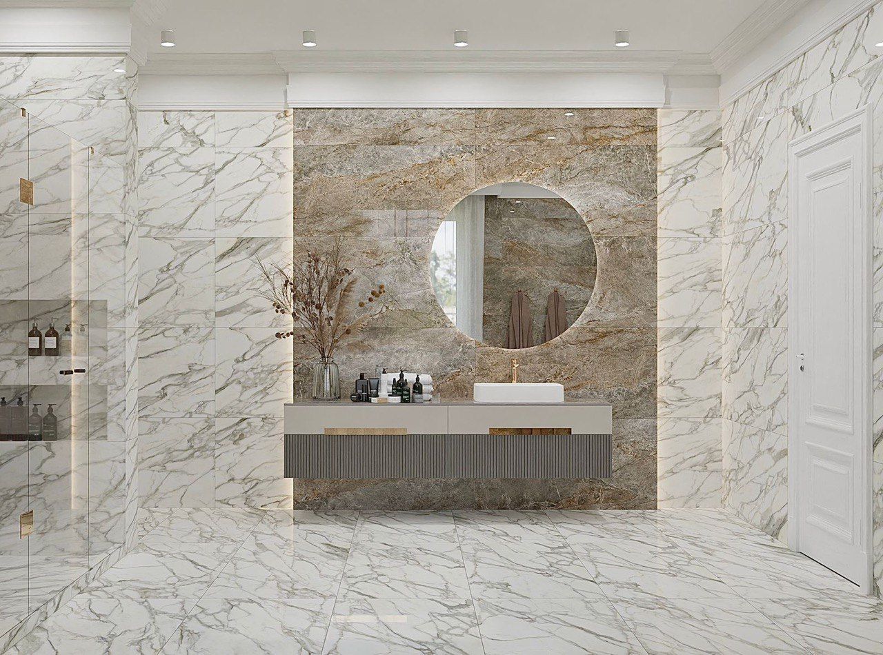A bathroom with marble tiles , a sink and a mirror.