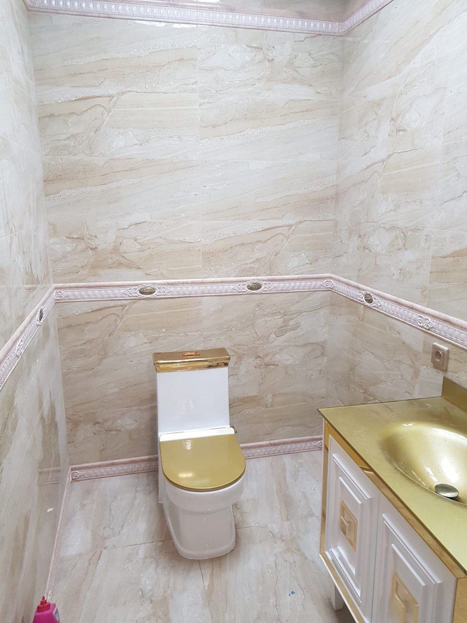 A bathroom with a toilet and a sink in it