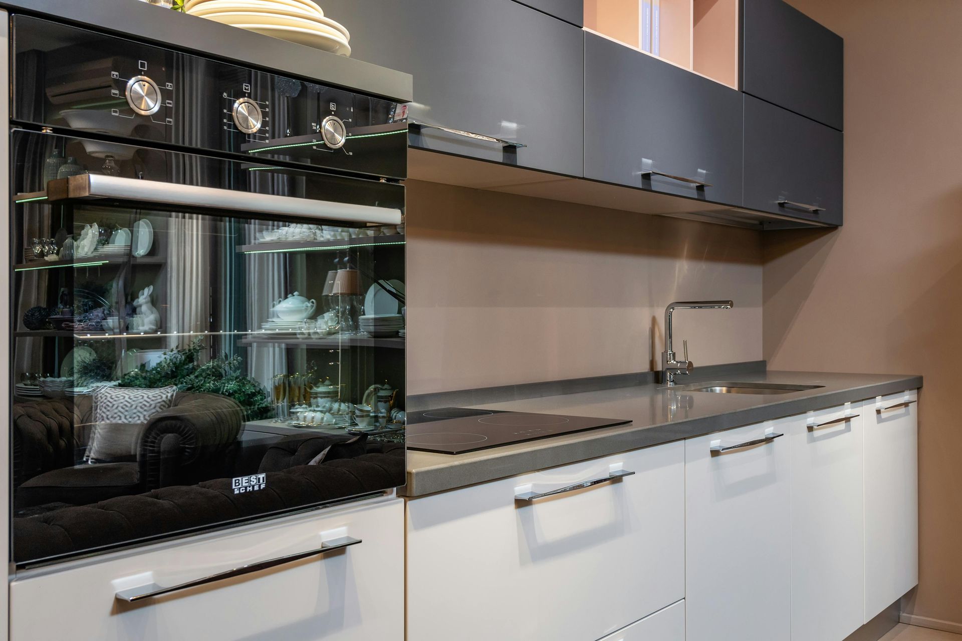 A kitchen with a sink , stove , and oven.