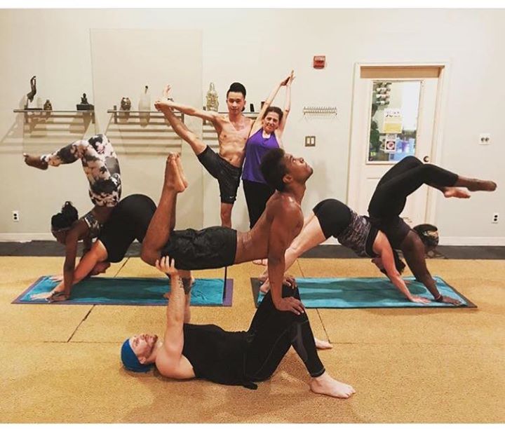 a group of people are doing yoga together at vinyasa flow hot yoga carle place
