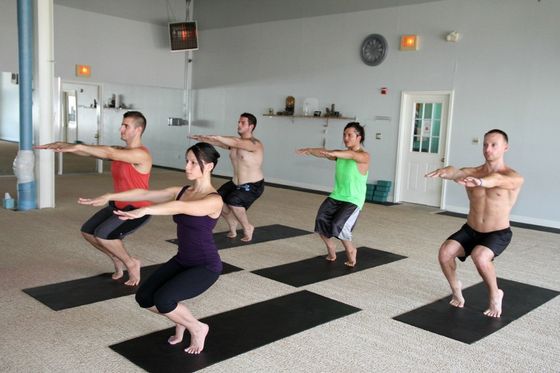 a group of people are doing hot yoga at hot yoga carle place
