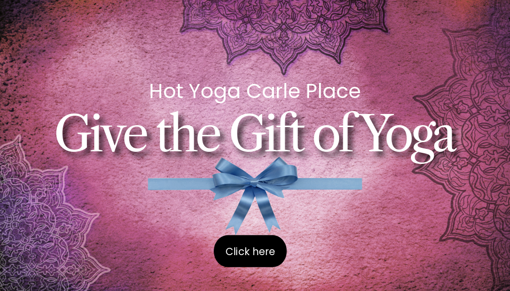 A purple background gift card link with the words `` give the gift of yoga '' and a blue bow.