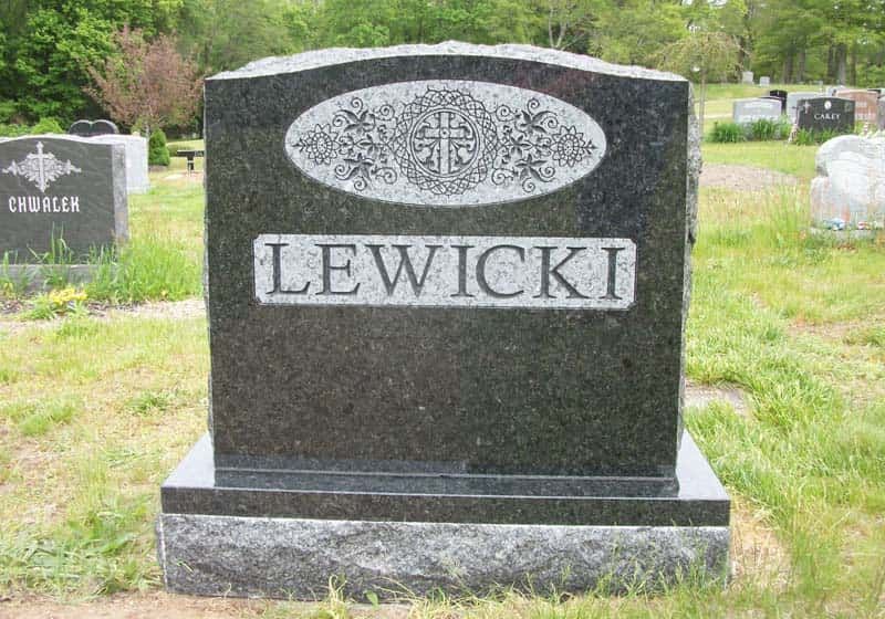 Black granite headstone in a cemetery with the surname 