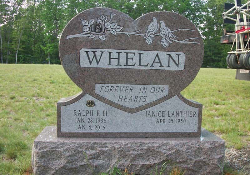Heart-shaped Whelan family gravestone in a grassy field. Features names, dates, and 