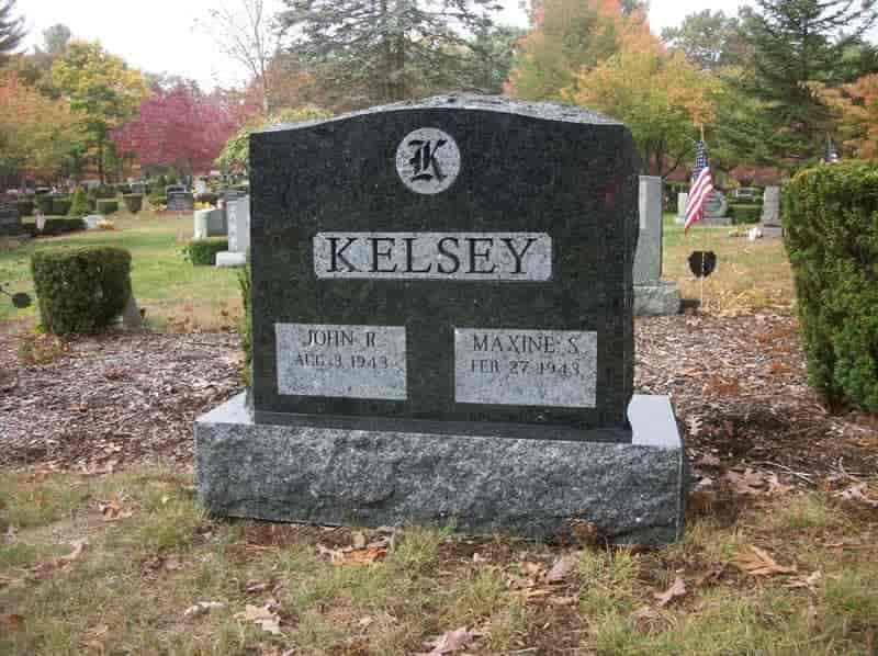 Granite headstone in a cemetery, with the last name 
