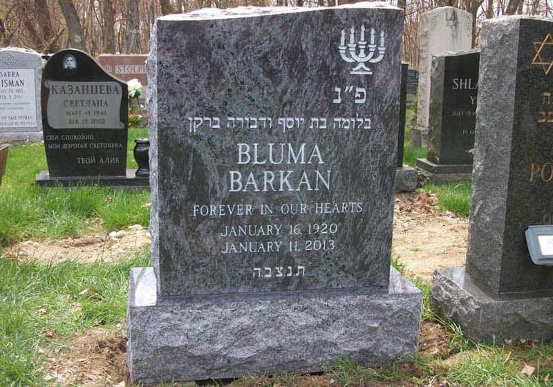 Tombstone for Bluma Barkan, gray granite, with Hebrew and English text, menorah, and dates 1920-2013.