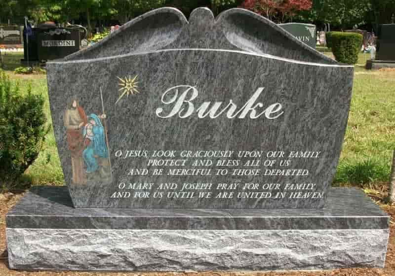 Gray granite Burke family headstone with religious scene and prayer.