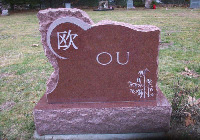 Red granite headstone in a cemetery, with 