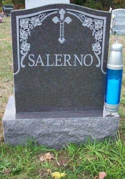 Gray headstone in a grassy cemetery, with 