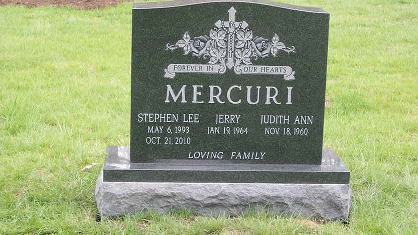 Headstone for the Mercuri family in a grassy setting. The names, dates, and 