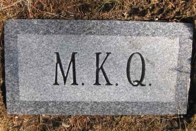 Gray granite headstone with the initials 