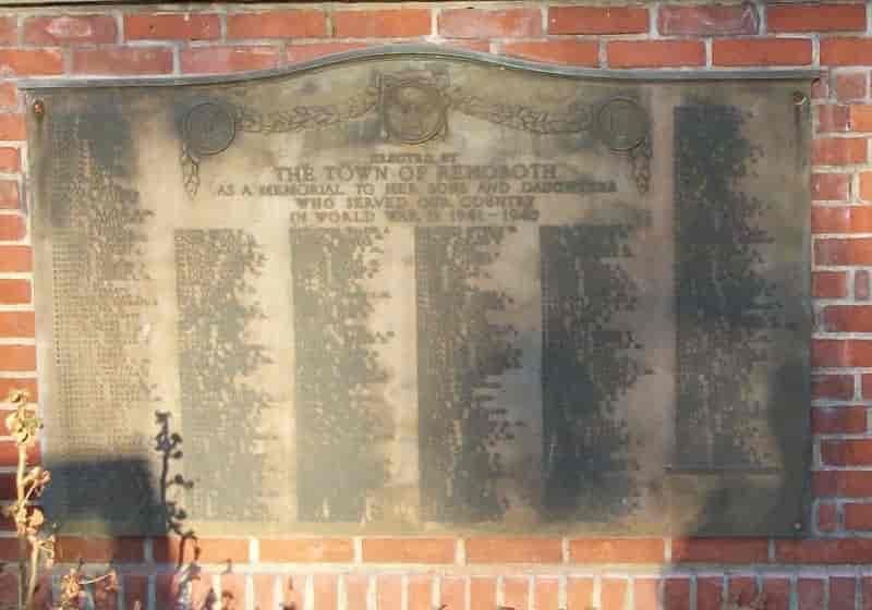 Bronze plaque on a brick wall; dedicated to the town of Penrhos and its servicemen in World War I.