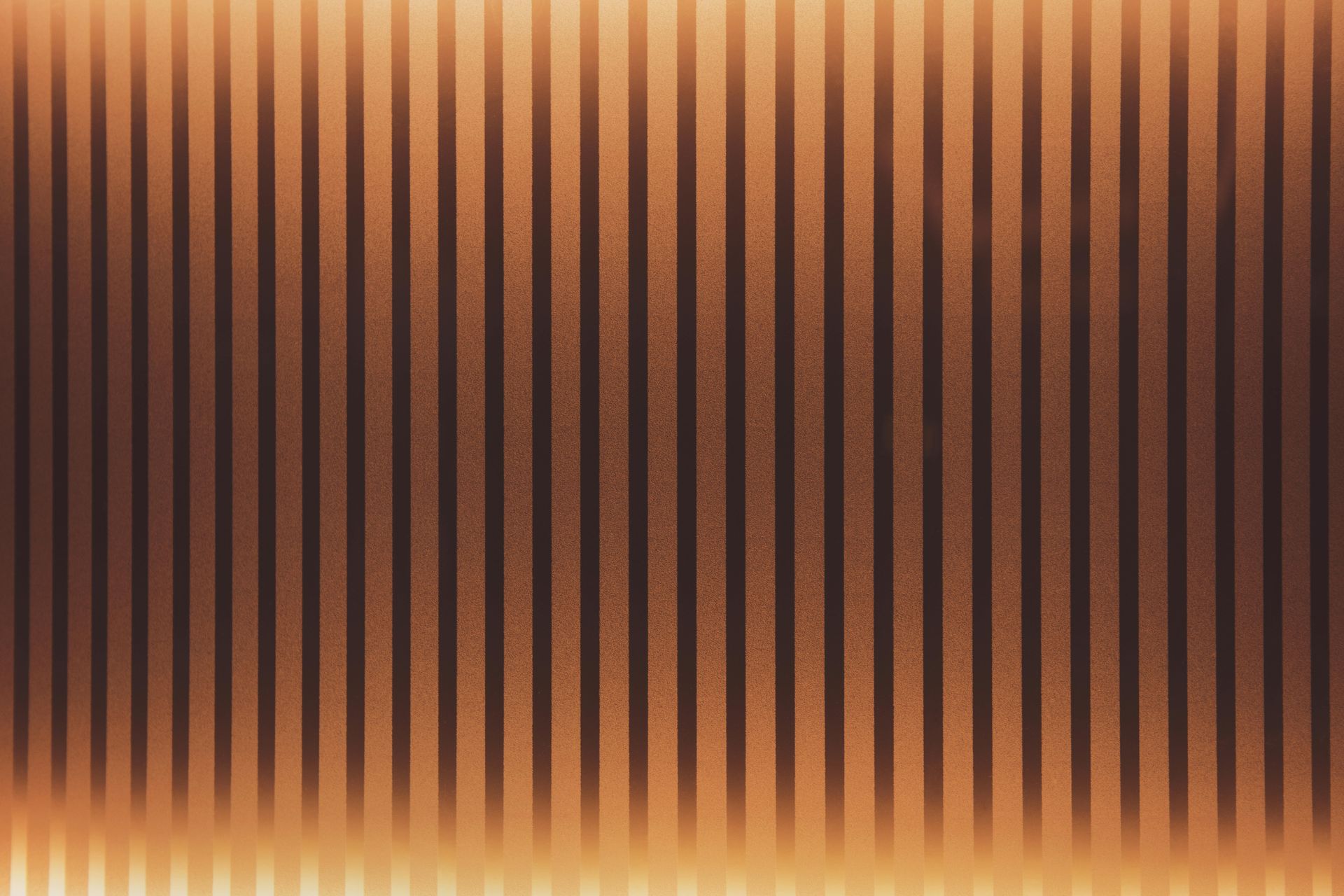 A close up of a brown and black striped background.