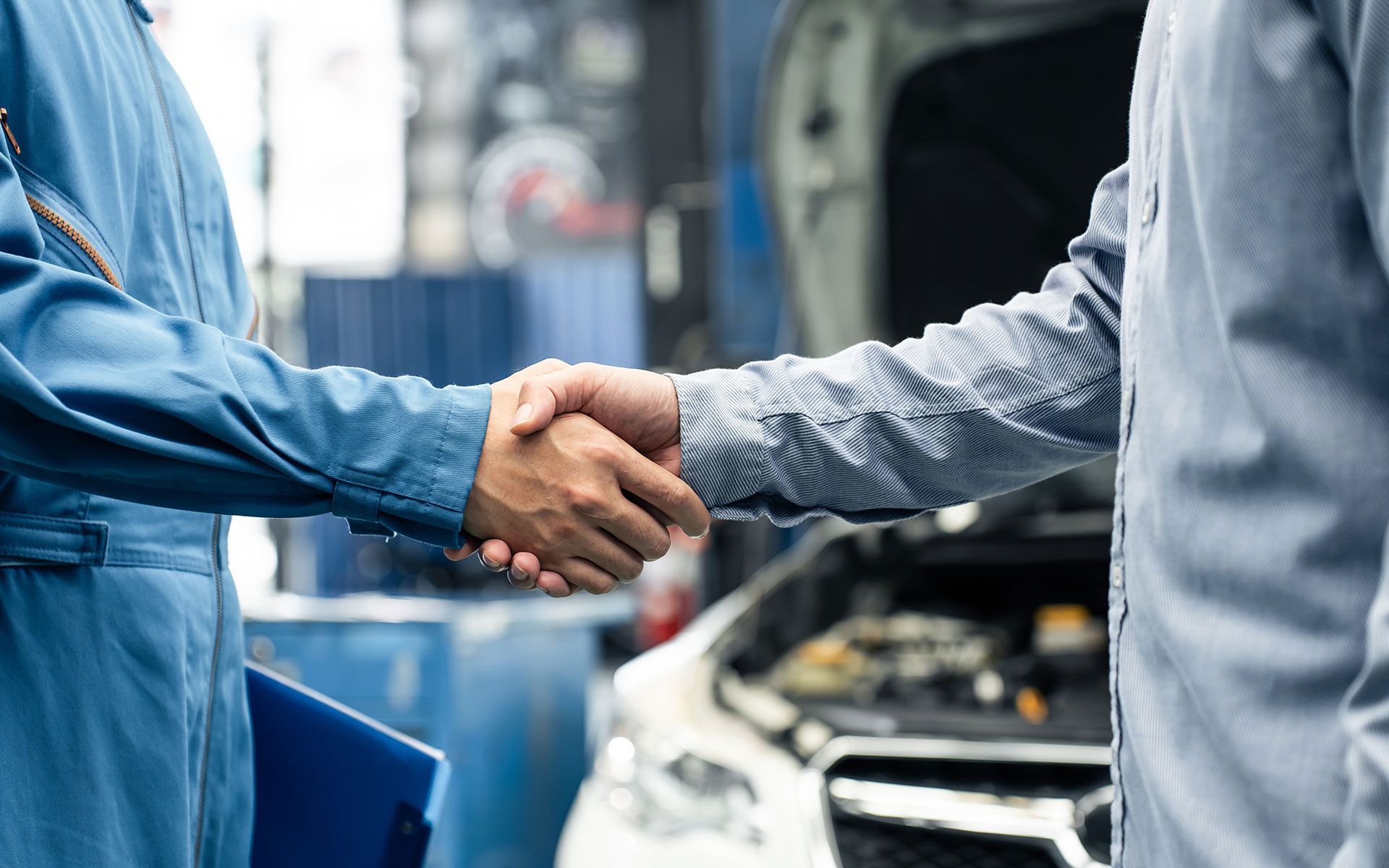 A bulldozer is plowing a field with mountains in the background.