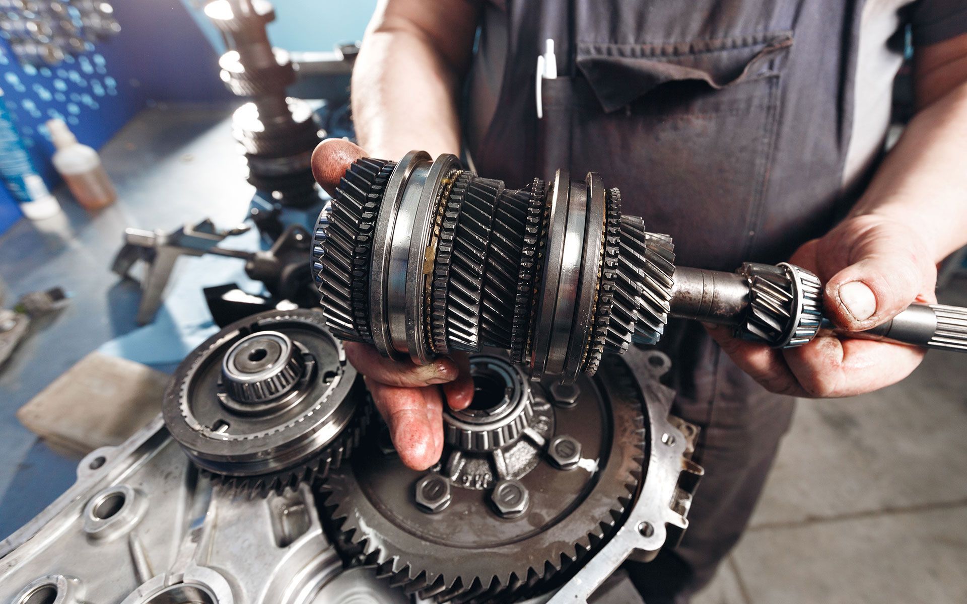 A bulldozer is plowing a field with mountains in the background.