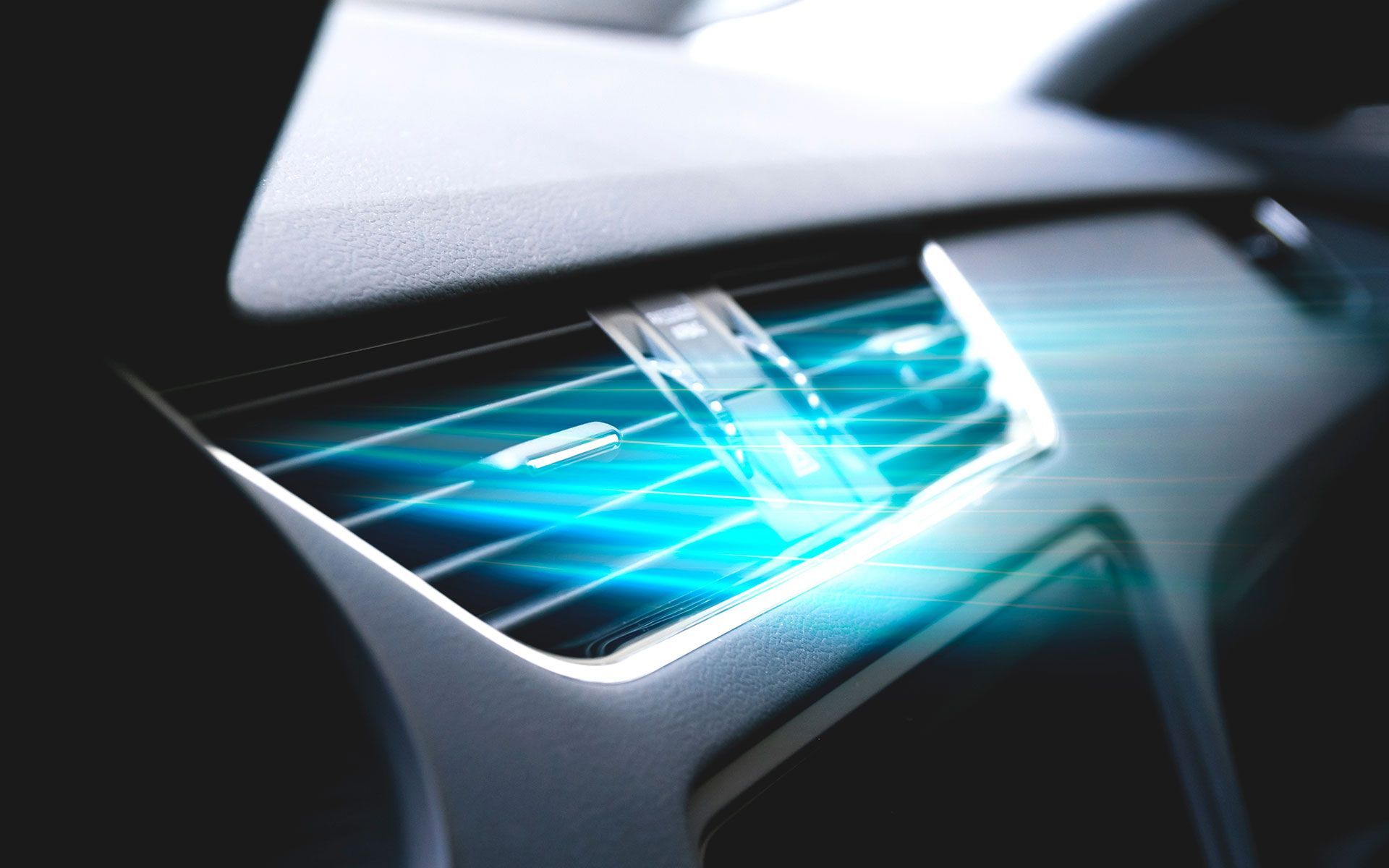 A bulldozer is plowing a field with mountains in the background.