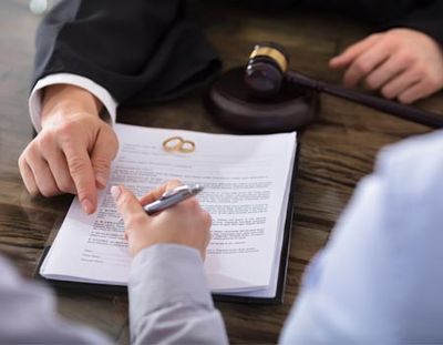 Divorce Attorney —Couple Signing on a Paper in Mclean, VA