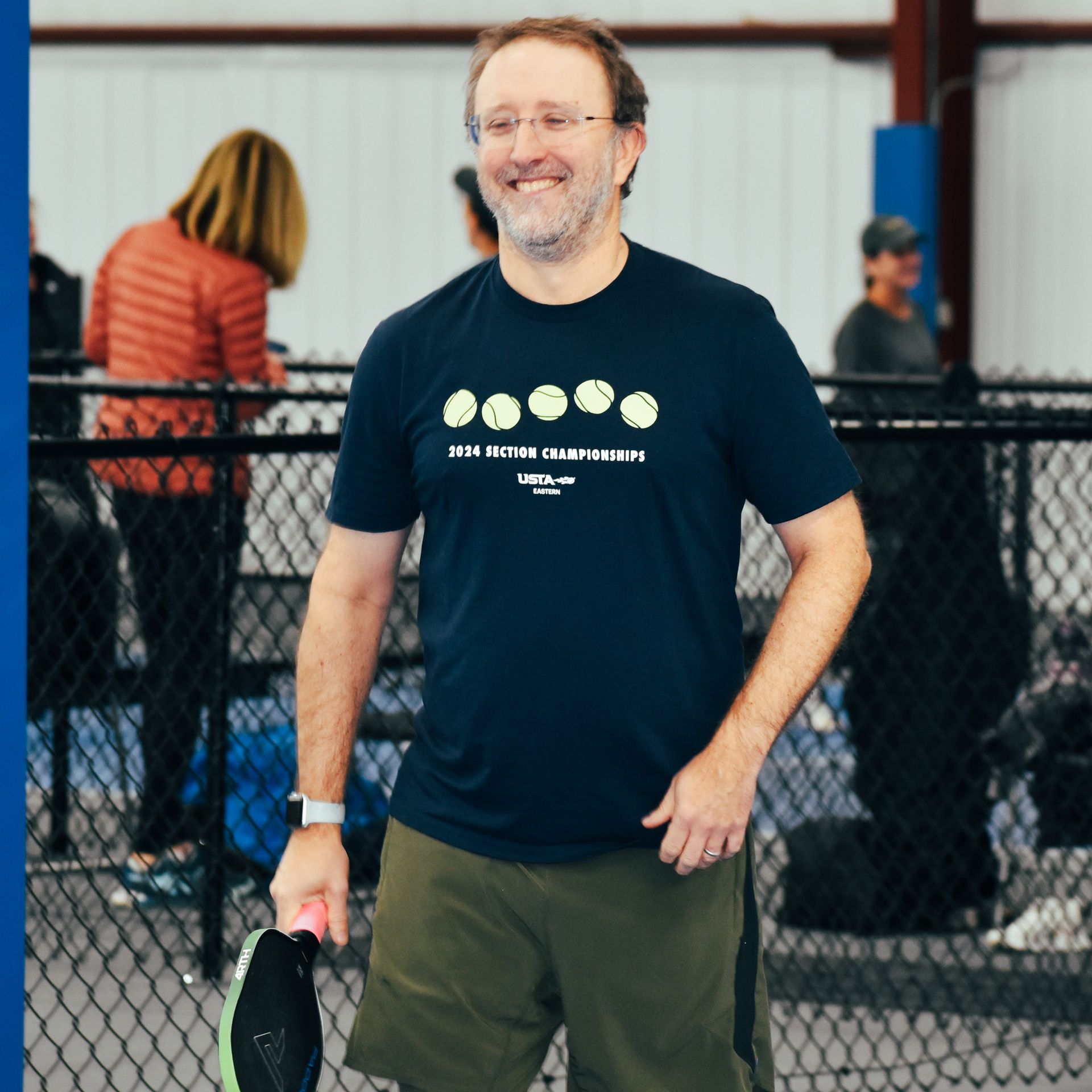 male pickleball playing laughing